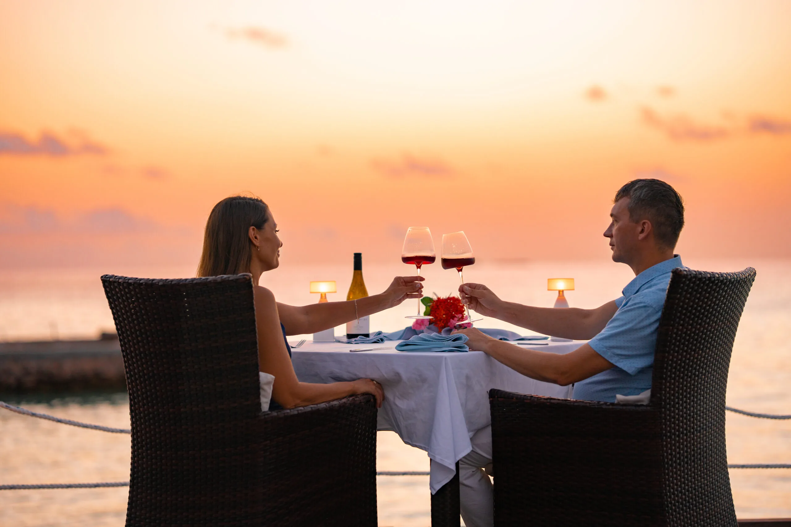 Couple enjoying a sunset beach dinner