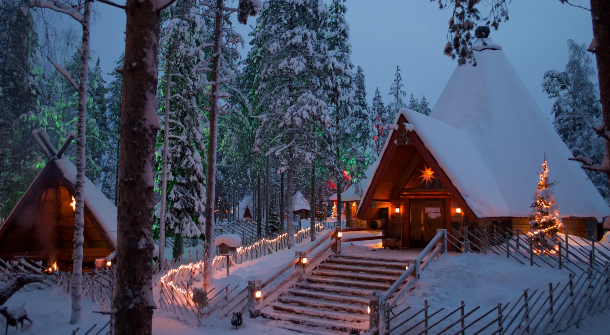 A log cabin lit up in the snow, Rovaniemi