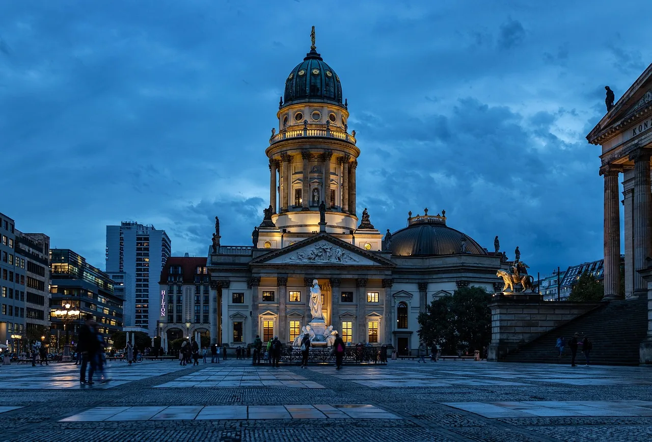 A domed church on a central Berlin square at blue hour