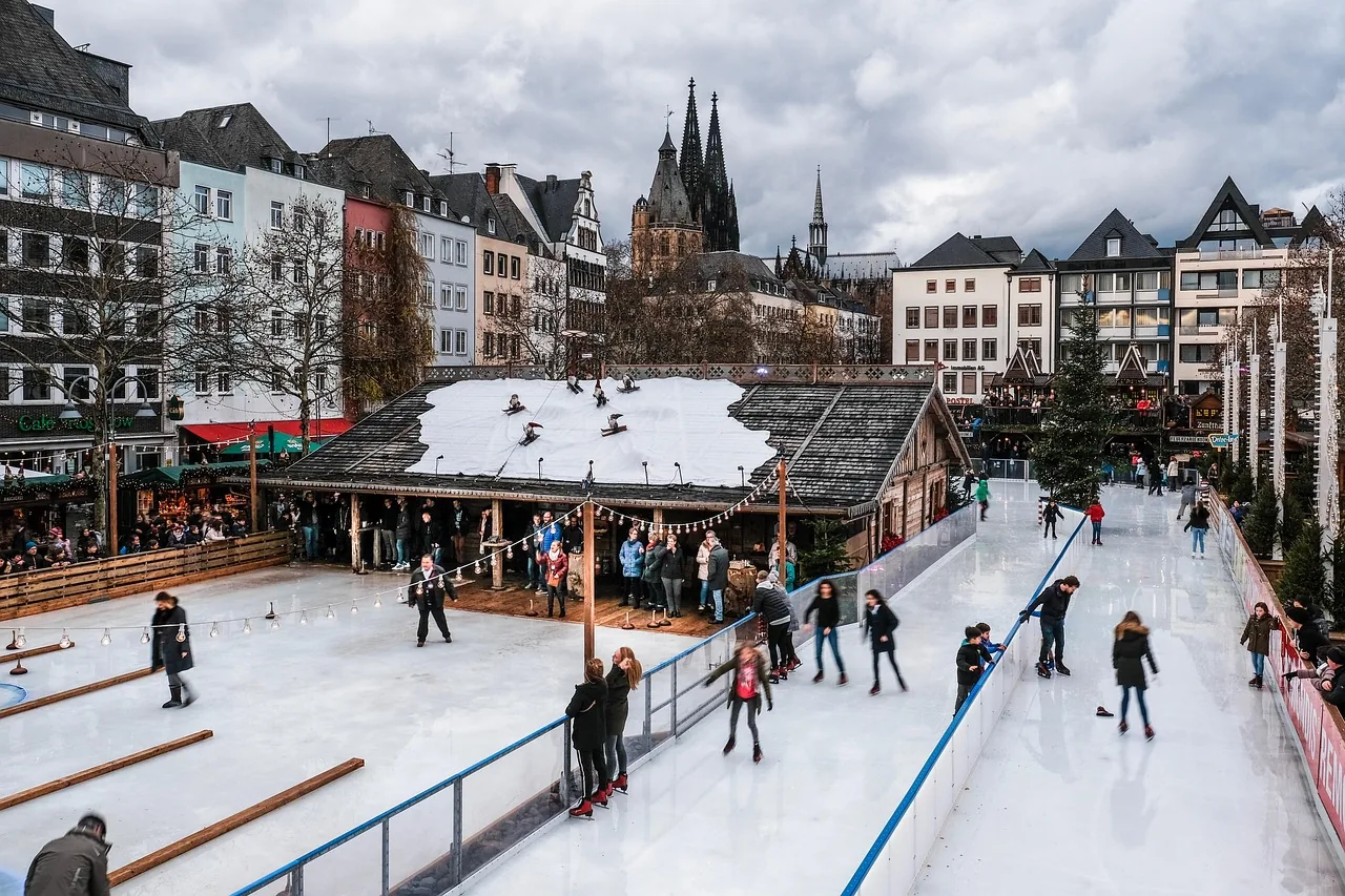 Christmas market ice rink in Cologne's old town, with the cathedral spires behind