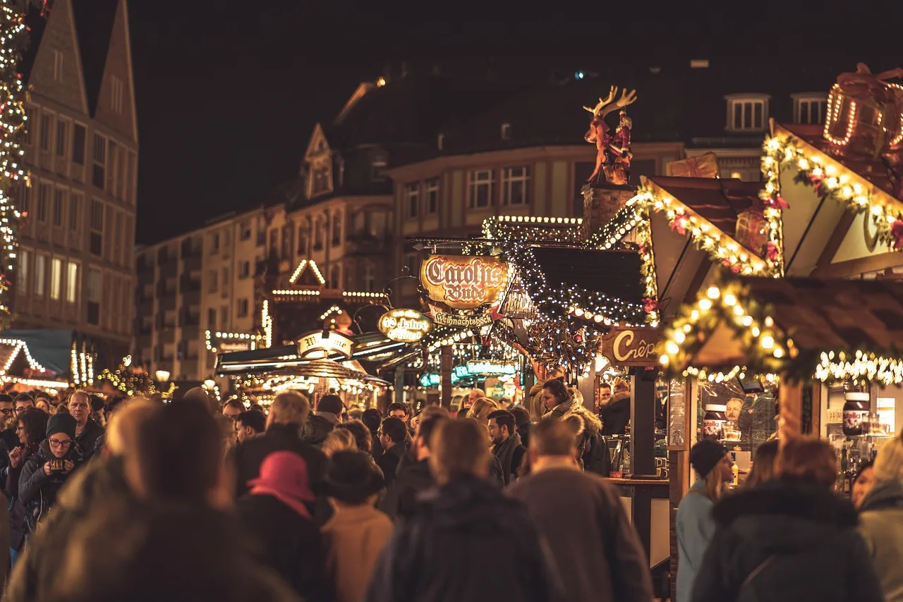 Crowds among the lit stalls of Frankfurt's Christmas market