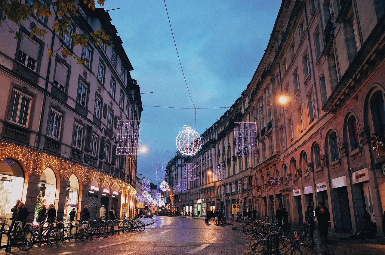 Christmas lights over a street in Strasbourg at dusk