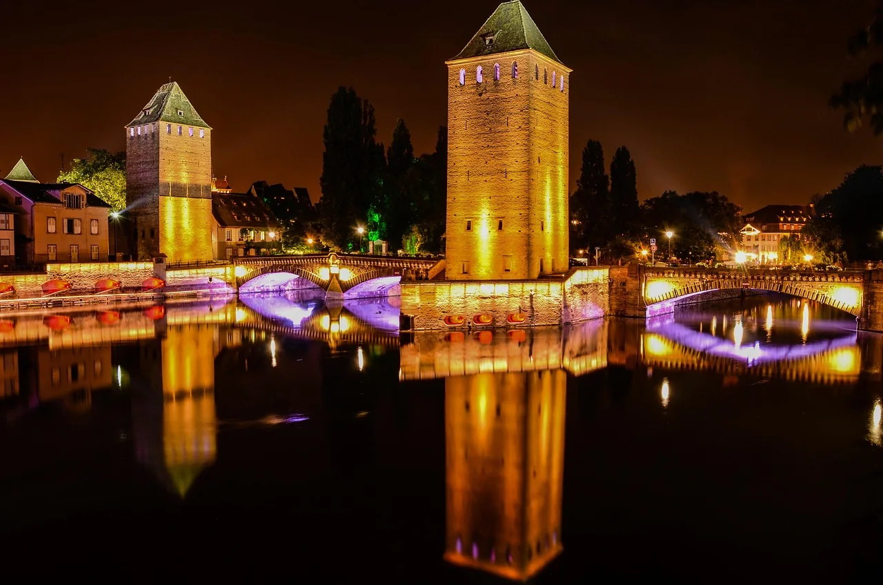 The Ponts Couverts towers in Strasbourg lit at night