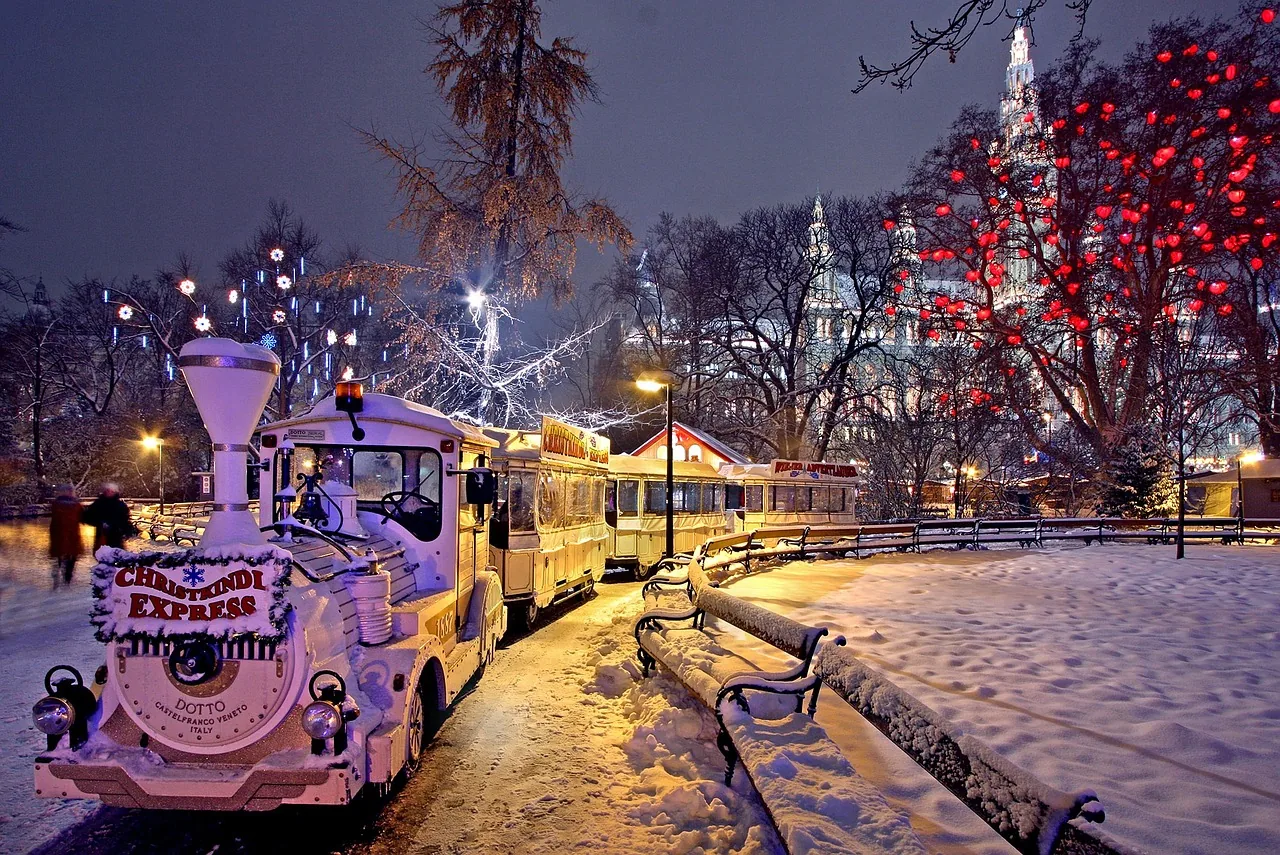 Christmas market lights in Vienna, with a children's train ride in the snow